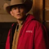 Jimmy Hurd strom wearing a red jacket with '6666' on it and a cowboy hat indoors.