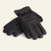 Rip Wheeler Pair of black leather gloves on a light beige background