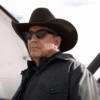 John Dutton wearing a cowboy hat and sunglasses with a neutral background
