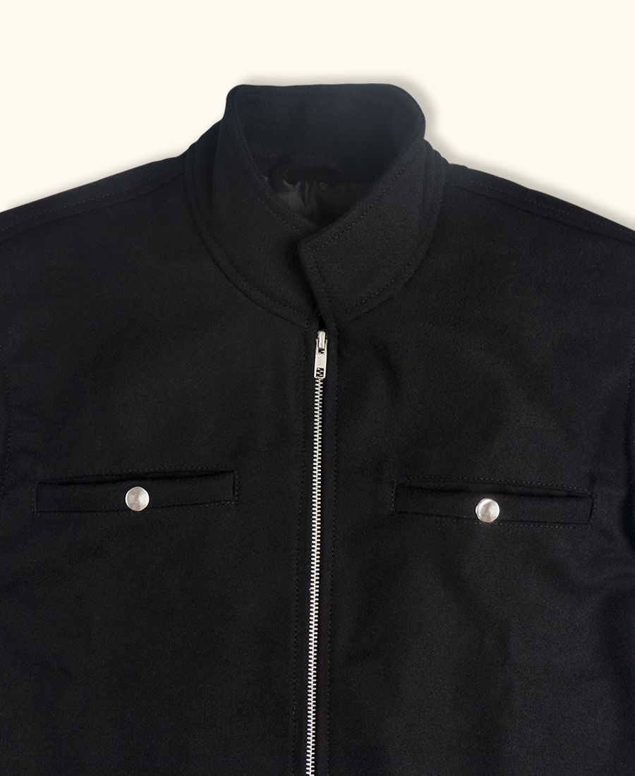 Black wool vest with a zipper on a white background closeup