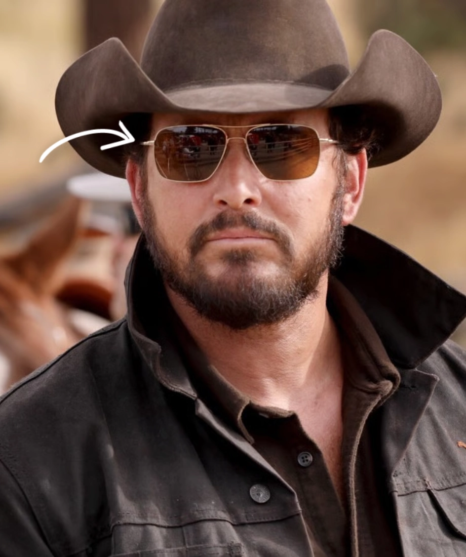 Rip Wheeler wearing a cowboy hat and sunglasses with a blurred background