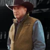 Man wearing a cowboy hat, brown vest, and blue shirt john dutton wool vest