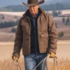 yellowstone john dutton in a brown quilted jacket and cowboy hat holding a rope in a scenic yellowstone